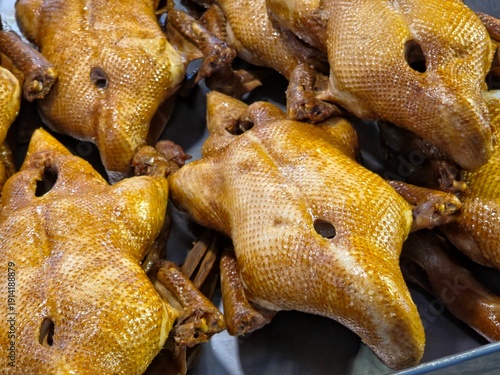 Photography Several Whole Chinese Braised Ducks with  Golden Skin Arranged on a Metal Tray at a Fresh Market