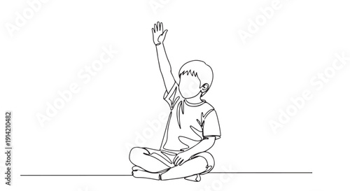 A young student with their hand raised, eager to answer a question in a classroom setting, sitting on the floor