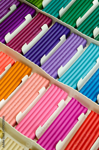 Pieces of multi-colored plasticine in a cardboard box