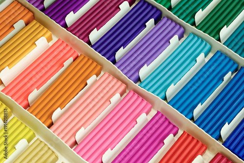 Pieces of multi-colored plasticine in a cardboard box