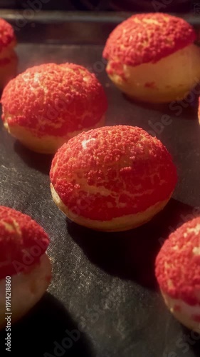 Profiteroles baking in oven. Choux pastry with craqueline. Timelapse of profiterole production. Homemade food growth in oven. Bakery concept. French dessert. Vertical. Brewing cake. Close-up in 4K