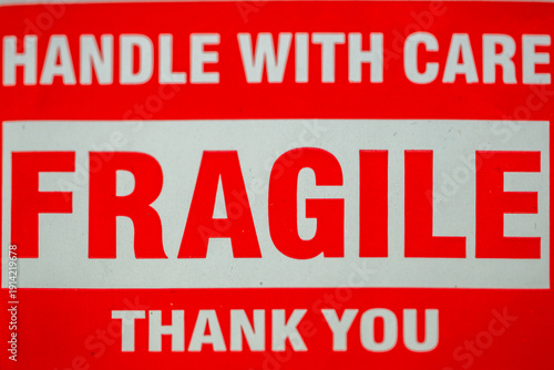 Warning sign shows message about fragile items and handling instructions for safety awareness