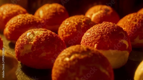 Profiteroles baking in oven. Choux pastry with craqueline. Bakery concept. Timelapse of profiterole production. French dessert. Homemade food growth in oven. Brewing cake. Red top. Close-up in 4K, UHD