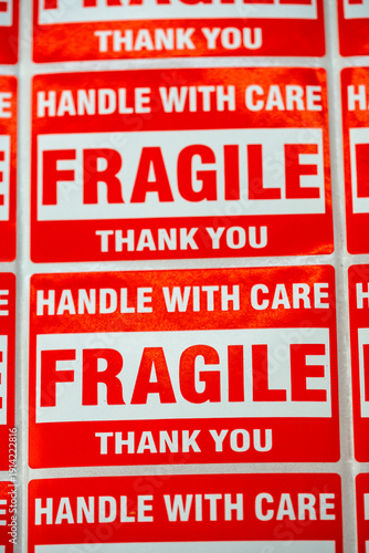 Handle with care stickers on packaging showing important safety messages at a shipping facility