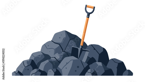 Large pile of dark grey coal or stone boulders with a metal shovel featuring a wooden handle stuck into the center of the heap.