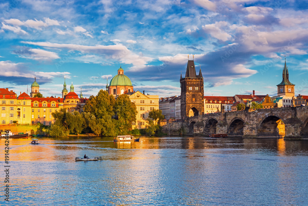 Naklejka premium Charles Bridge (Karlův most) in Prague, Czech Republic, spanning the Vltava River with historic towers and Gothic architecture. Panoramic view of the medieval bridge and city skyline, iconic European 