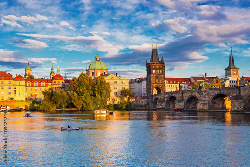 Charles Bridge (Karlův most) in Prague, Czech Republic, spanning the Vltava River with historic towers and Gothic architecture. Panoramic view of the medieval bridge and city skyline, iconic European 