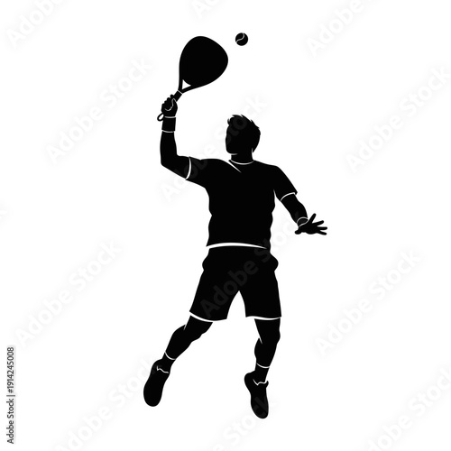 Silhouette of a male tennis player jumping to hit the ball during a match, action shot