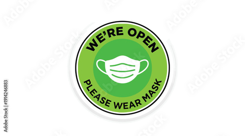 A green sign with a white mask and the words 'WE'RE OPEN PLEASE WEAR MASK' indicating a business is open during the pandemic with health precautions in place always.
