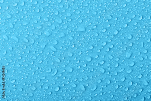 Water droplets on a blue surface show the effects of condensation in a simple and clear manner