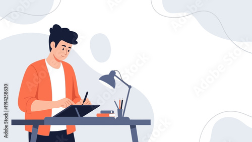 Young Man Digital Artist Drawing on Tablet at Desk with Lamp