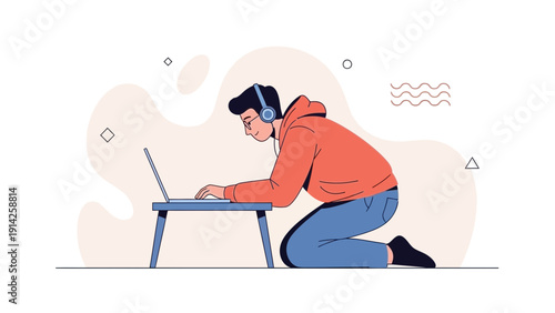 Young man wearing headphones, working on laptop while kneeling on floor