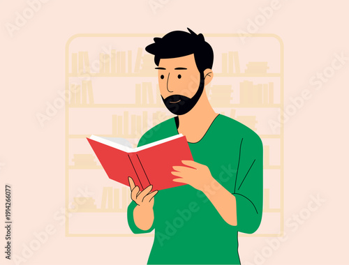 Man reading a red book in front of bookshelves