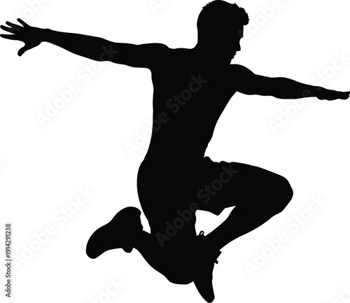 Energetic man jumping in mid-air with outstretched arms and bent knees