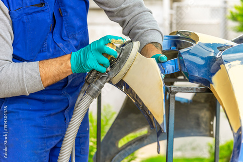 Bulgarian mechanic working in auto shop.