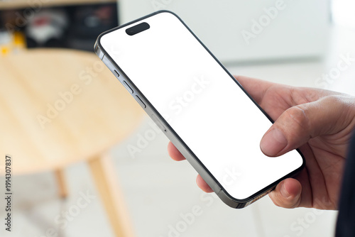 Person holding smartphone mockup with transparent screen PNG in blurred office lifestyle setting, concept of business productivity