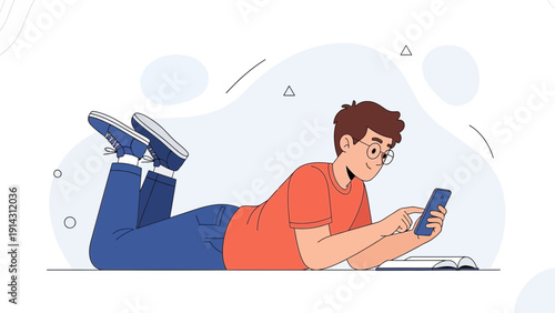 Young man lying down using smartphone, studying or relaxing with book