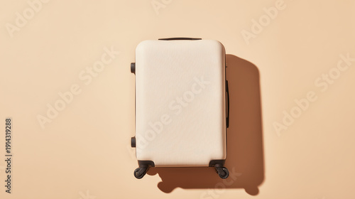 Beige hard shell suitcase on a soft peach background with natural shadow, minimalist travel concept for vacation, business trip, packing, and stylish, organized departure planning