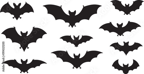 A collection of various bat silhouettes in different flying poses against a white background