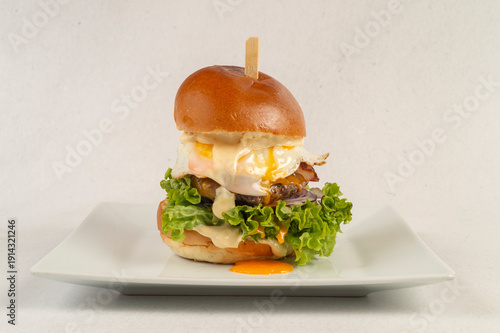 burger with meat and egg and vegetables