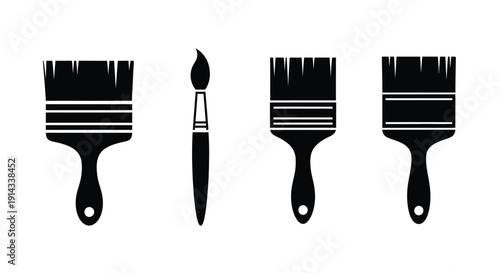 Four paintbrushes displayed in a striking black silhouette