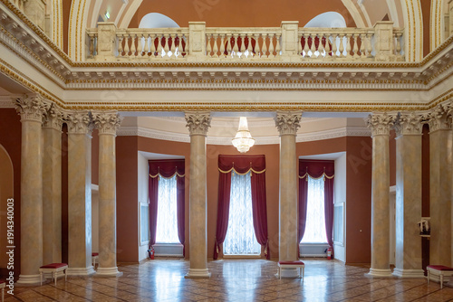 Luxury classical interior with marble columns and red curtains