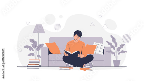 Young man reading a book while sitting on the floor in a cozy living room