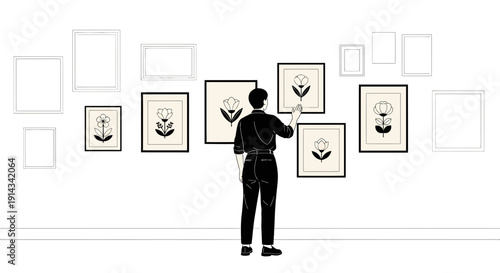 Artist Arranging Framed Botanical Art on Gallery Wall