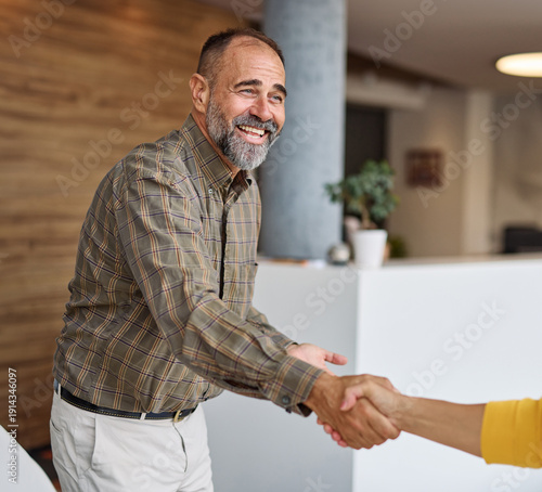 Wallpaper Mural Group of  businesspeople having a meeting shaking hands handshake introducing each other and applauding during meeting in the office. Teamwork and success concept, portrait of a middle aged mature bus Torontodigital.ca