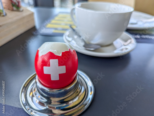 Wallpaper Mural An egg in colors of the Swiss national flag on the breakfast table Torontodigital.ca