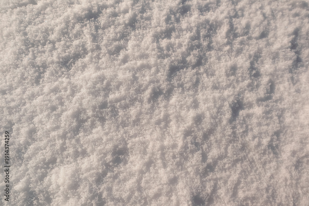Obraz premium Sparkling hoarfrost and ice crystals on fresh snow in bright winter sunlight.