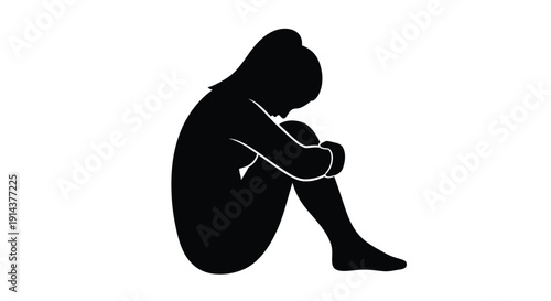 A solitary figure head bowed in quiet contemplation silhouette