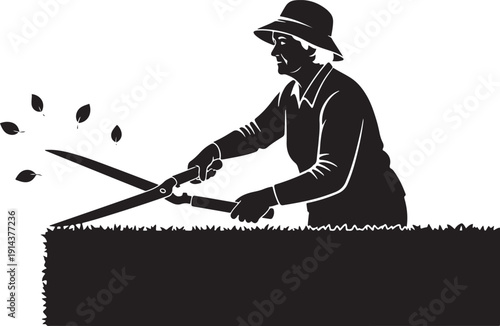 Silhouette of a woman in a hat trimming a hedge with shears, with leaves blowing in the wind.
