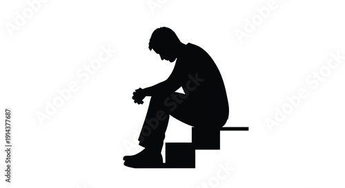 A man sits on steps in a dramatic black silhouette