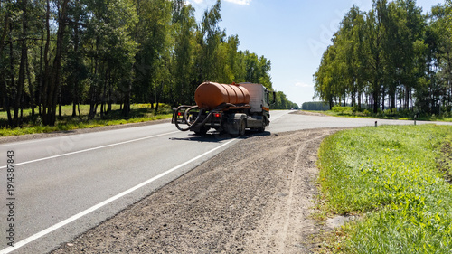 Tableau sur toile Sewage truck in motion on a forest road