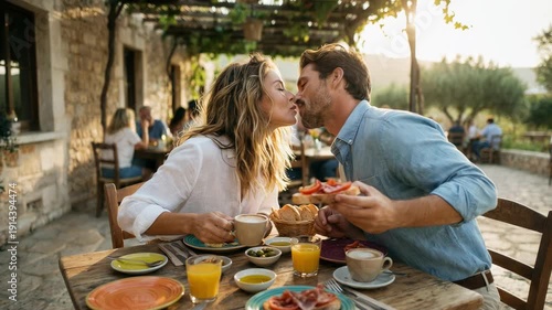 Romantic couple having breakfast together on vacation, sharing a tender kiss, stylish modern outfits, joyful and smiling, warm sunrise colors, relaxing holiday atmosphere