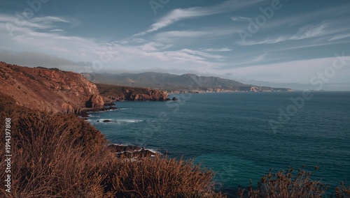 Coastline View With Cliffs and Ocean Under a Cloudy Sky at Midday Near a Coas...