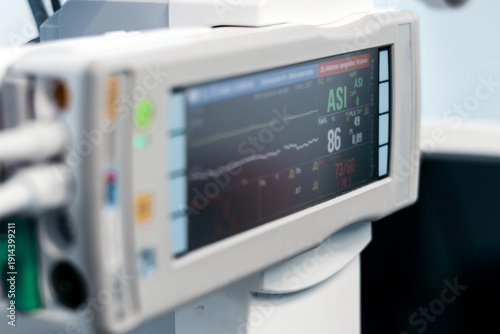 Obraz na płótnie Medical monitor displaying vital signs with numerical data and waveforms in a cl