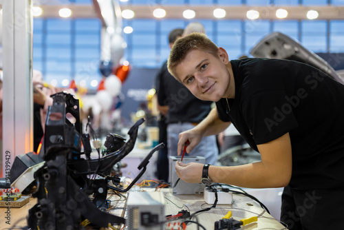 Young student learning car electronics at vocational school