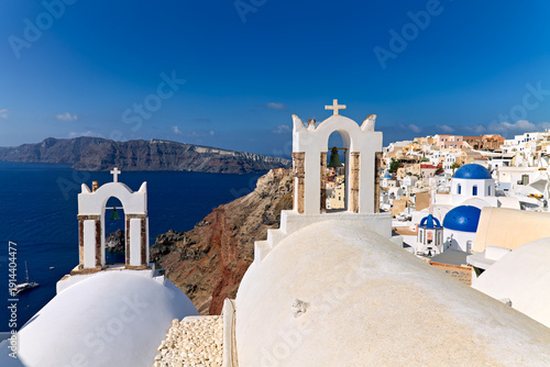 Santorini's iconic white churches, blue domes, and caldera view.