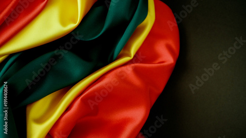 Pan African Color Silk Waves on Dark Background Celebrating Heritage and Freedom