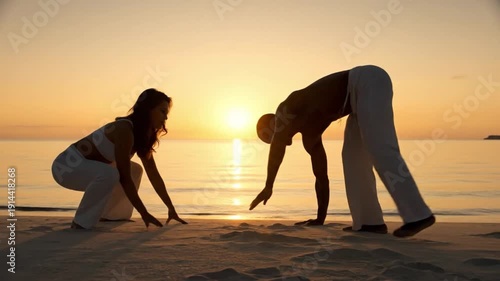 Capoeira practitioners performing on a tropical beach at sunset.