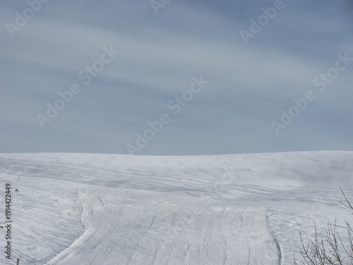 Snowy Cliff Edge with Vast Winter Sky View