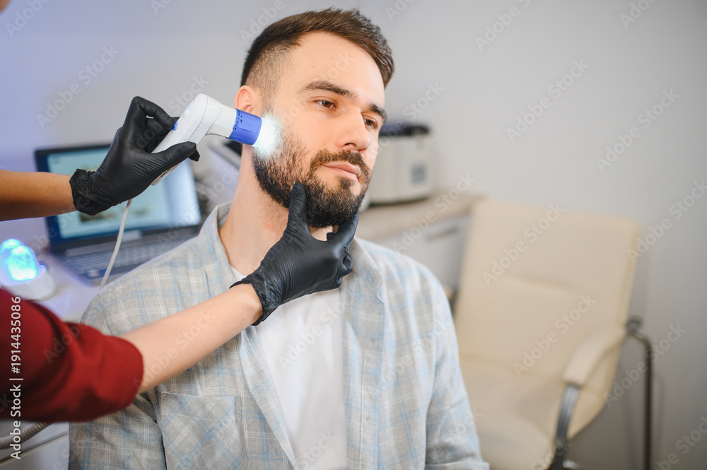Naklejka premium Patient receiving hair and beard growth examination