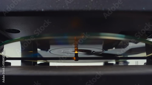 Wallpaper Mural Close-up view of a spinning vinyl record on a turntable, showcasing the needle's movement and the reflective surface of the disc in a modern audio setup Torontodigital.ca