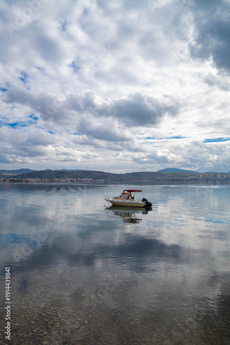 Wallpaper Mural With calm, reflective sea and boats and cloudy sky Torontodigital.ca