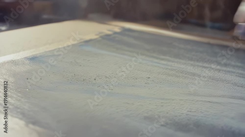 Wallpaper Mural Close-up view of paint being applied to a canvas in a studio setting, showcasing the gradual layering of colors and textures in an artistic process Torontodigital.ca