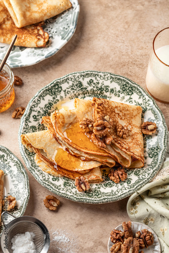 Canvastavla Delicious crepes served with nuts and honey folded on ceramic plate