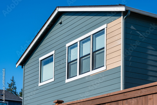 Εκτύπωση καμβά Newly built house with section of siding replacement, exterior wall with windows