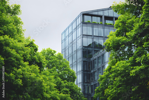 Wallpaper Mural Modern building surrounded by green trees in an urban area during cloudy weather Torontodigital.ca